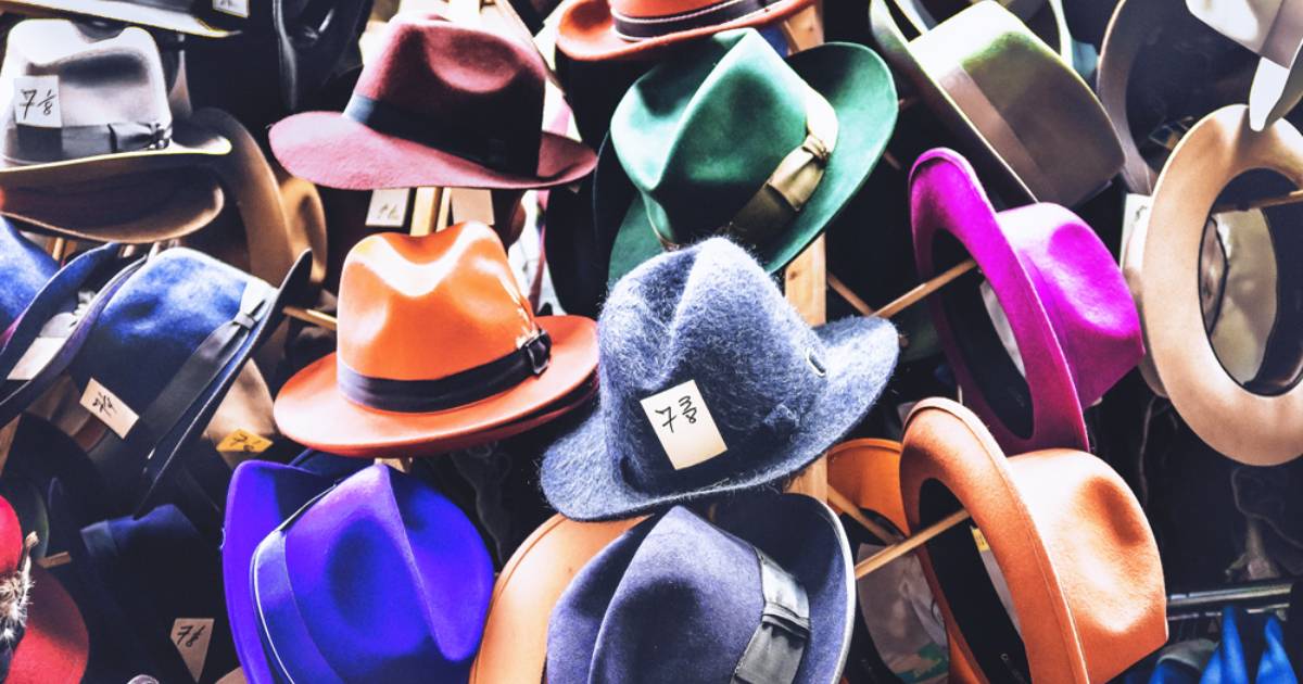Rack of hats symbolizing the crush of social content demands.