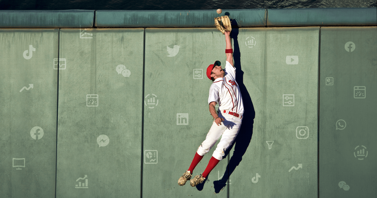 baseball player catching ball against wall