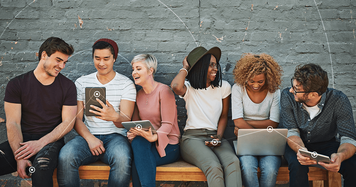 A group of six men and women on laptops and other devices, living in a digital entertainment world.