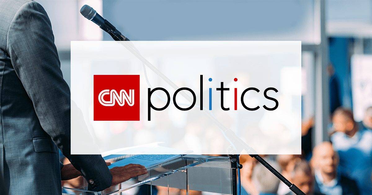CNN Politics logo on background of candidate addressing crowd.