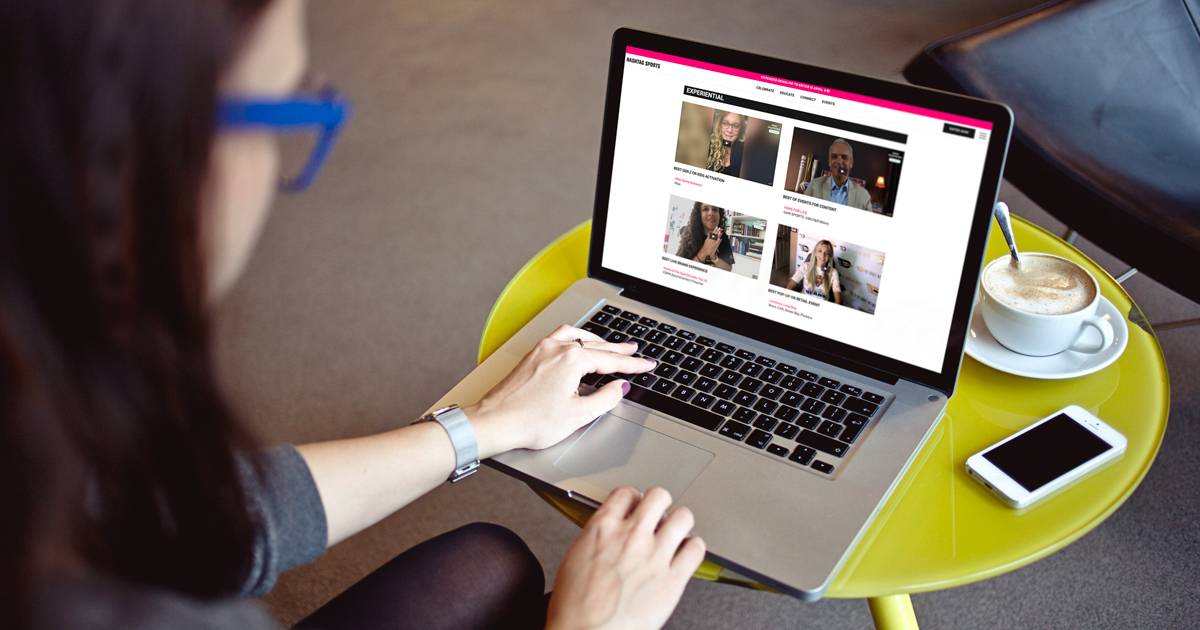 Woman watching the virtual Hashtag Sports event on laptop screen.