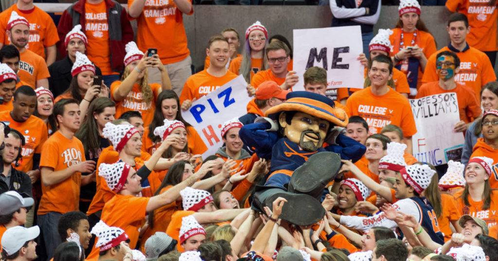 Fans celebrate their team and mascot while attending a game