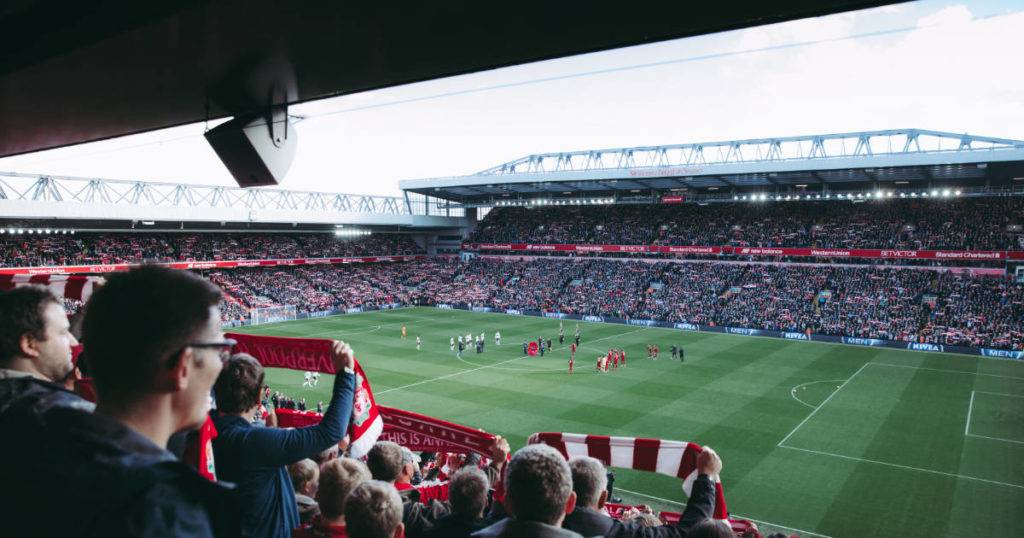 Crowd view onto match field, engage gen z sports fans.