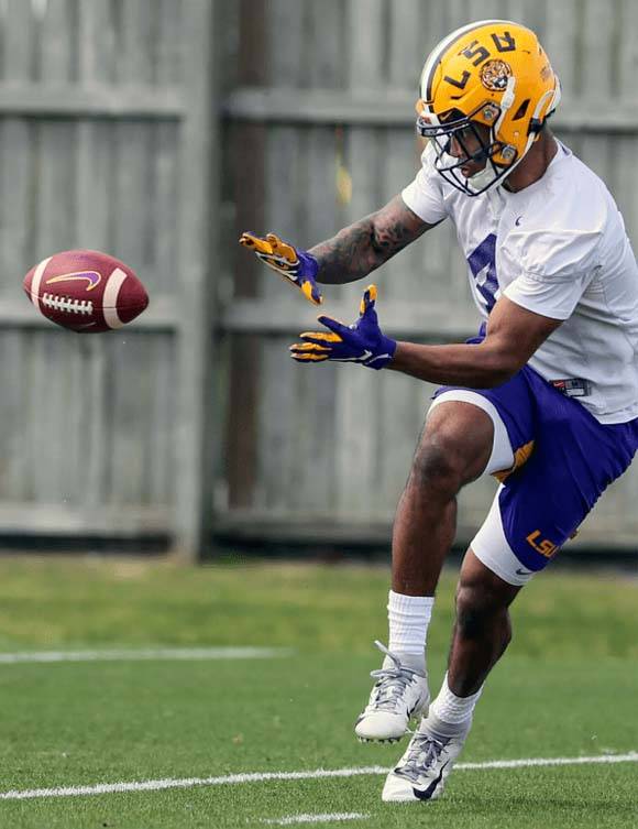 College student athlete catching a football