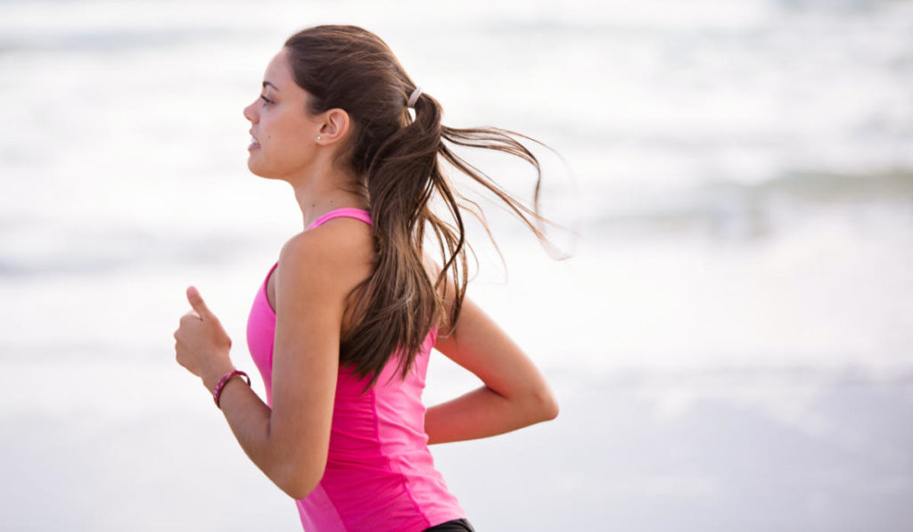 Woman running in pink shirt in sports marketing promotion