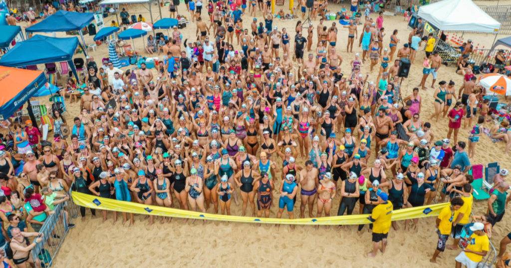 Sports social networking sites - photo of a crowd of athletes on beach.