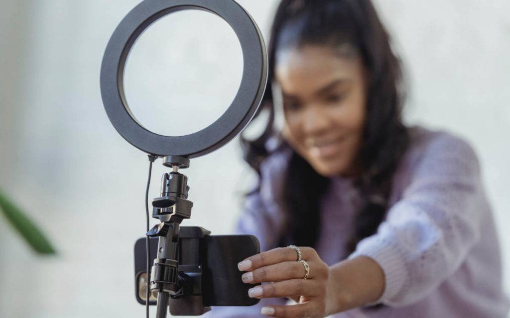 user-generated-content - woman with ring light on mobile phone