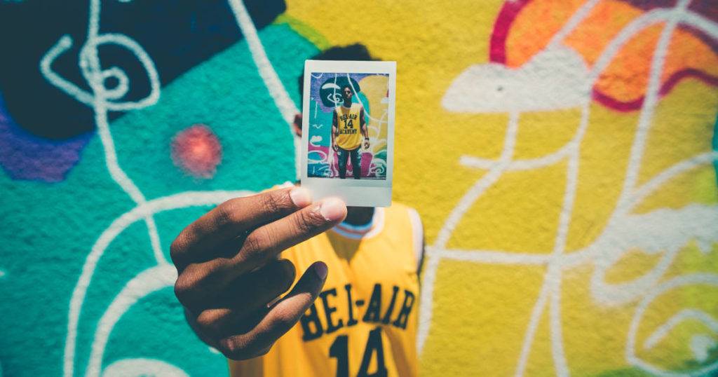user-generated-content-marketing athlete holding photo of himself