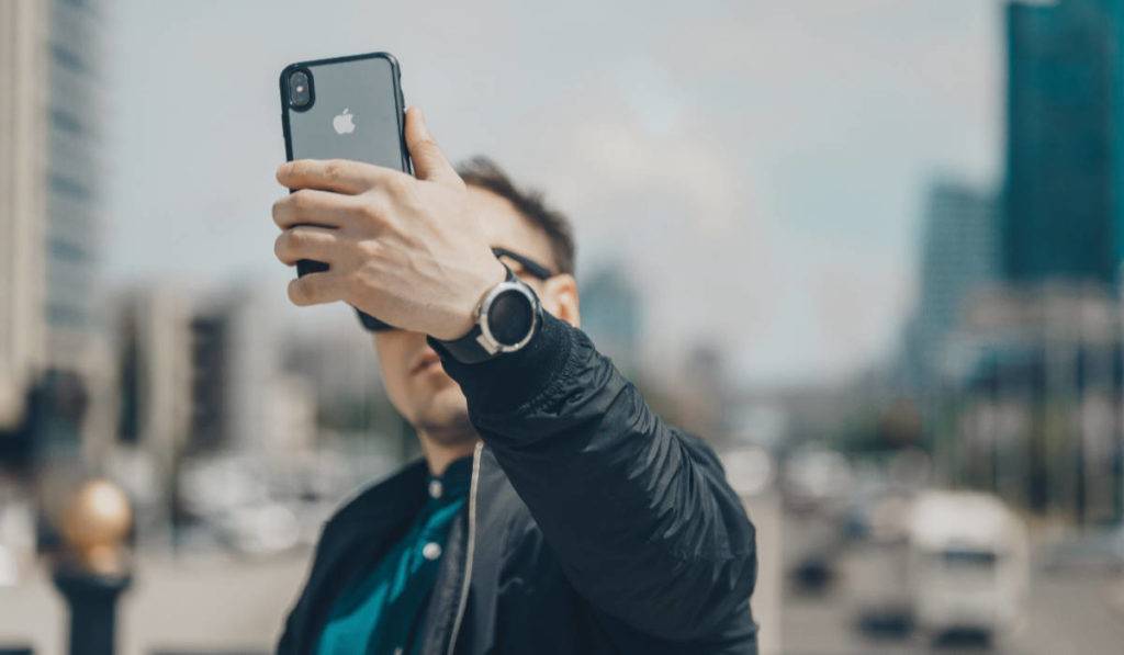 what-is-ugc man taking selfie outside