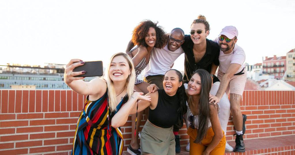 why-use-ugc group of friends taking rooftop selfie