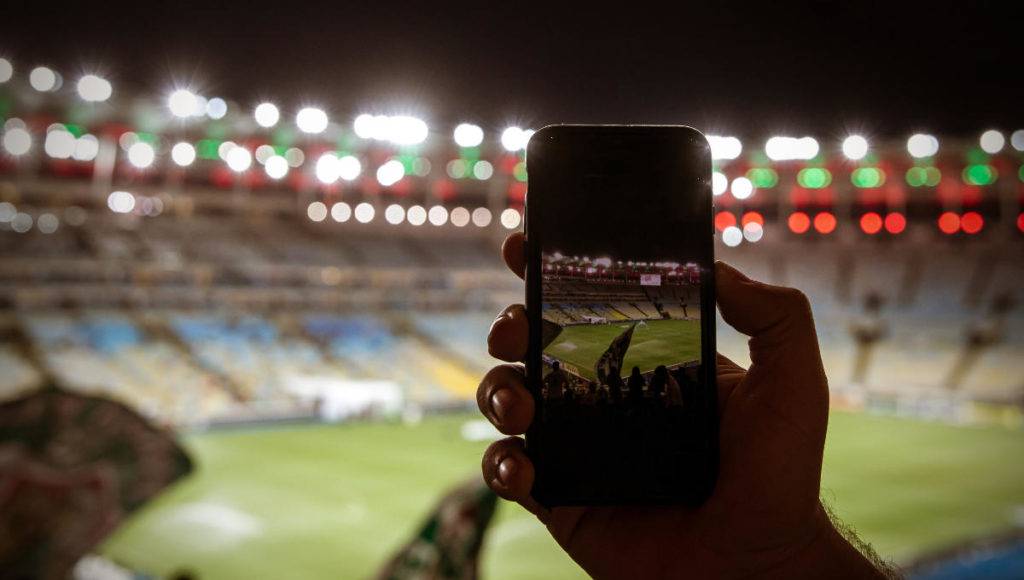 fan taking mobile photo in stadium for user generated content ideas