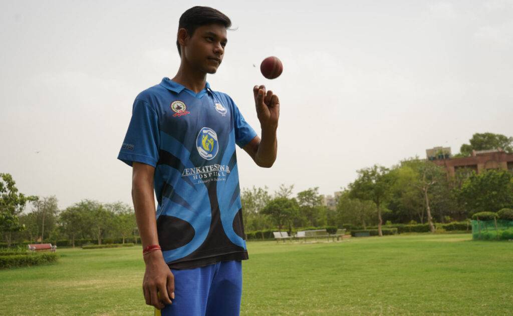 Cricket player with sponsor logo on jersey catching ball. AI for sports sponsors.