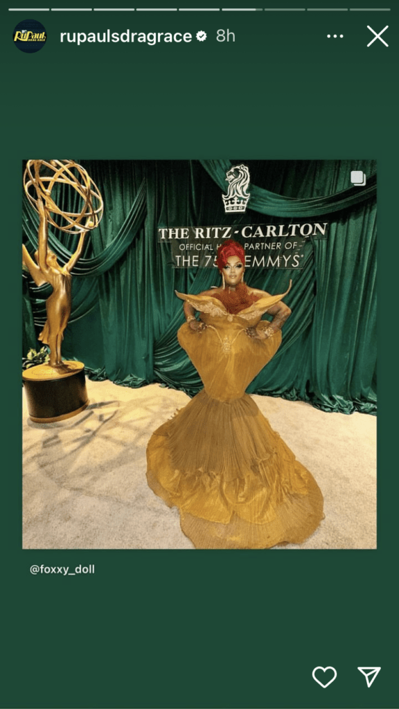 entertainment social media with Malaysia Babydoll Foxx image gold dress on red carpet next to Emmy Award statue.